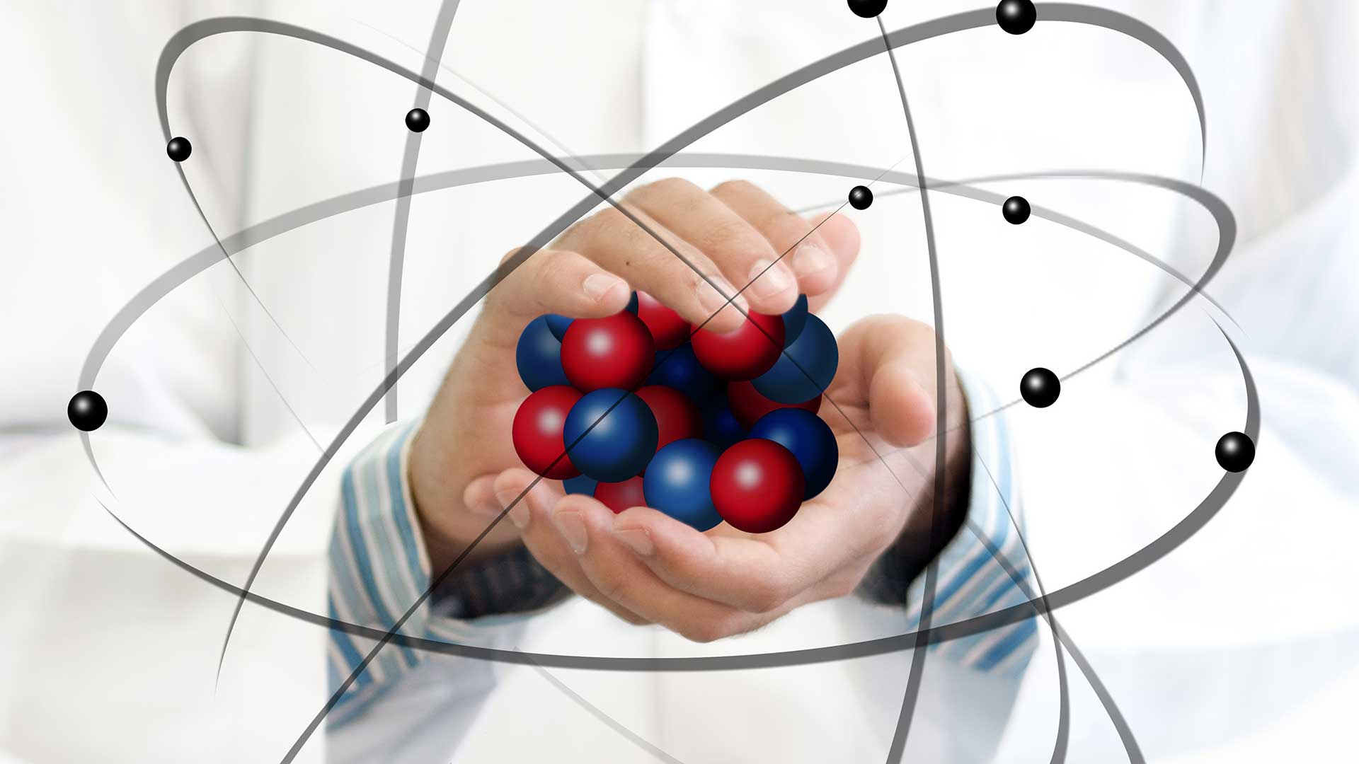 person holding balls representing atoms