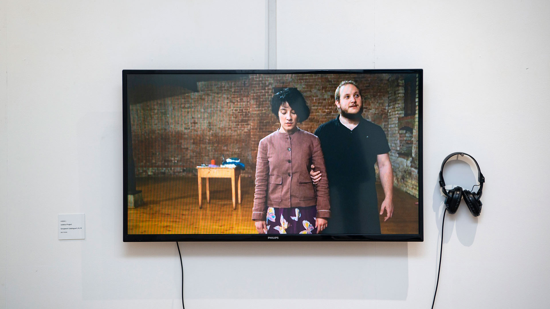 Image of a screen, on which a man and woman are displayed